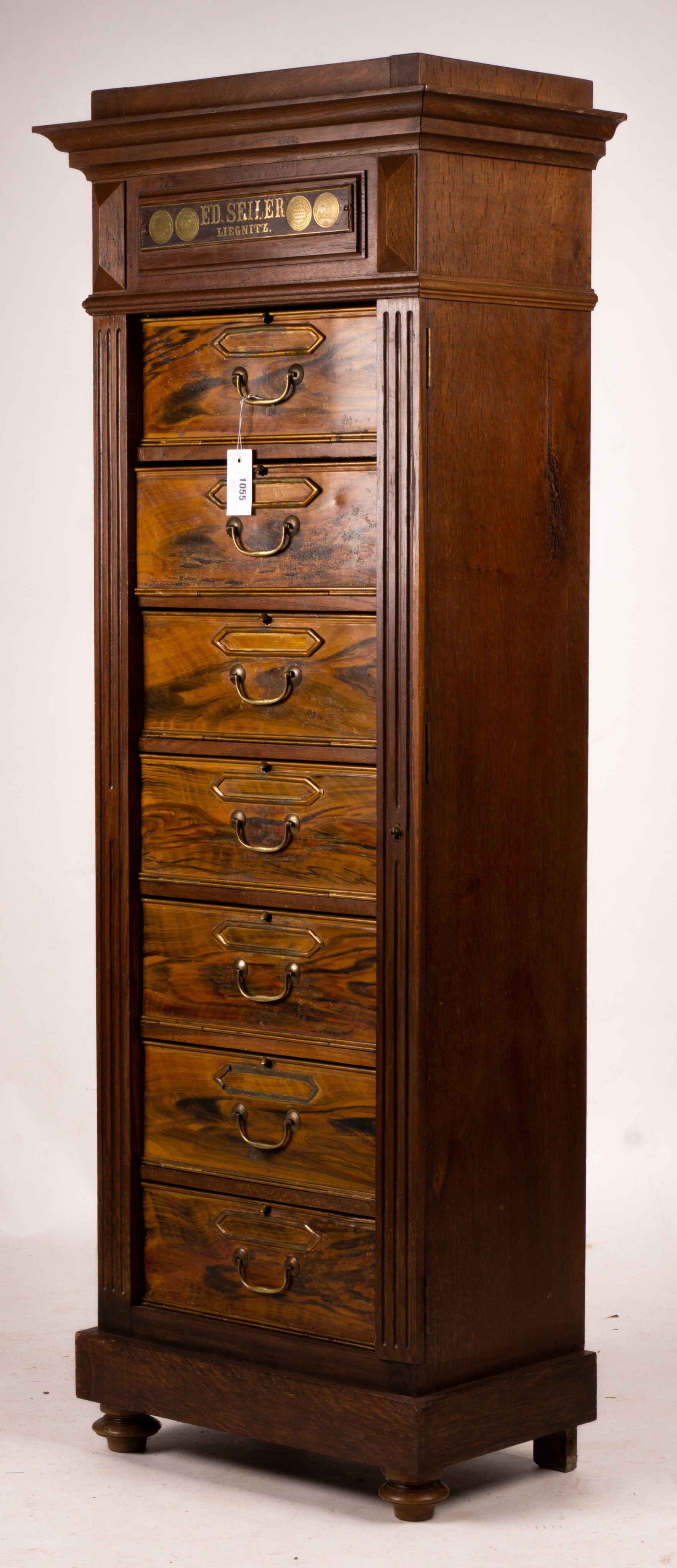 A late 19th / early 20th century oak and simulated walnut shop storage chest / filing cabinet, labelled Ed Seiler, width 57cm, depth 34cm, height 152cm